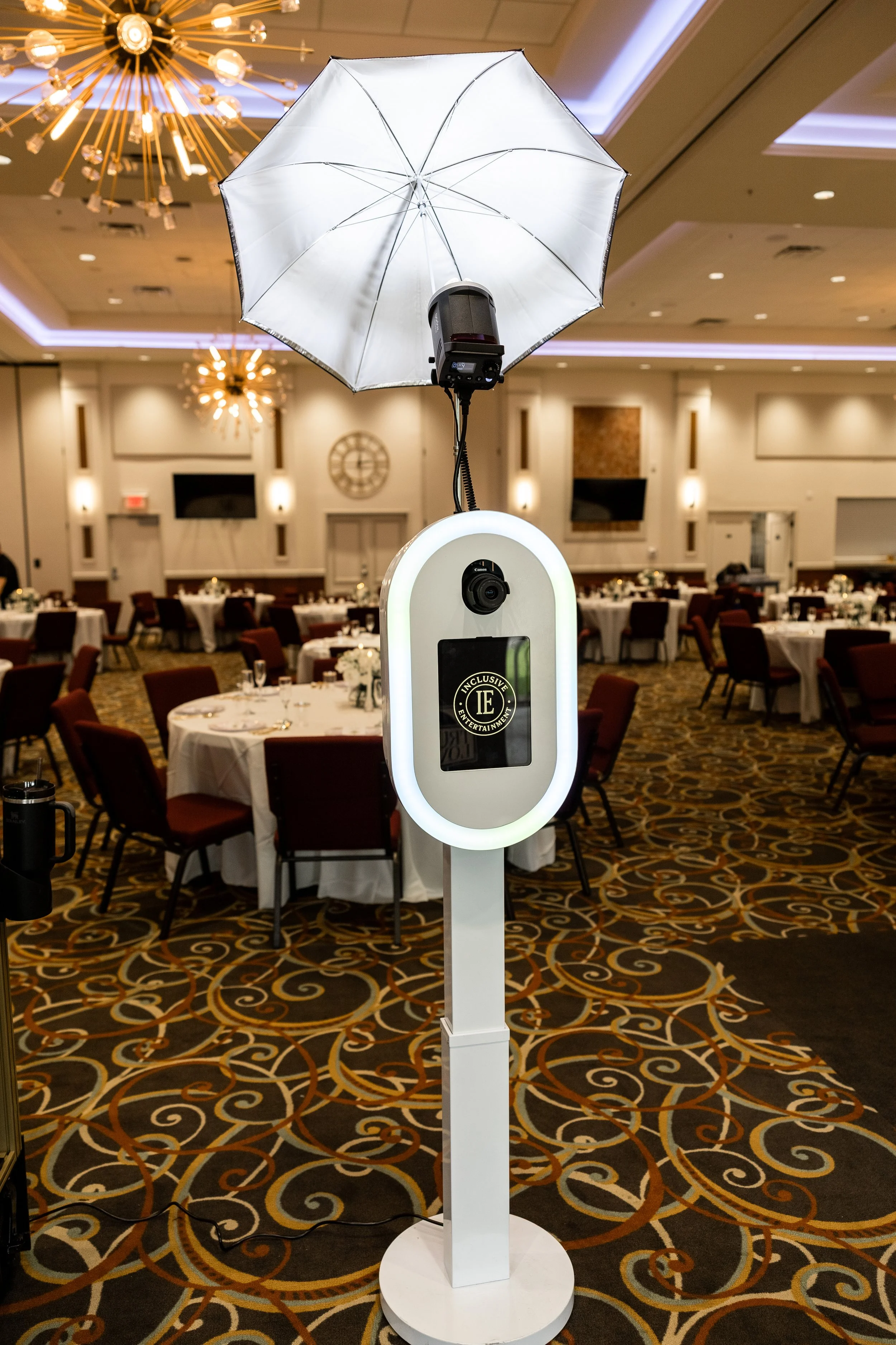 Professional DSLR photo booth with professional umbrella flash lighting setup at an indoor wedding reception banquet hall, Patty’s Pix by Inclusive Entertainment setup.