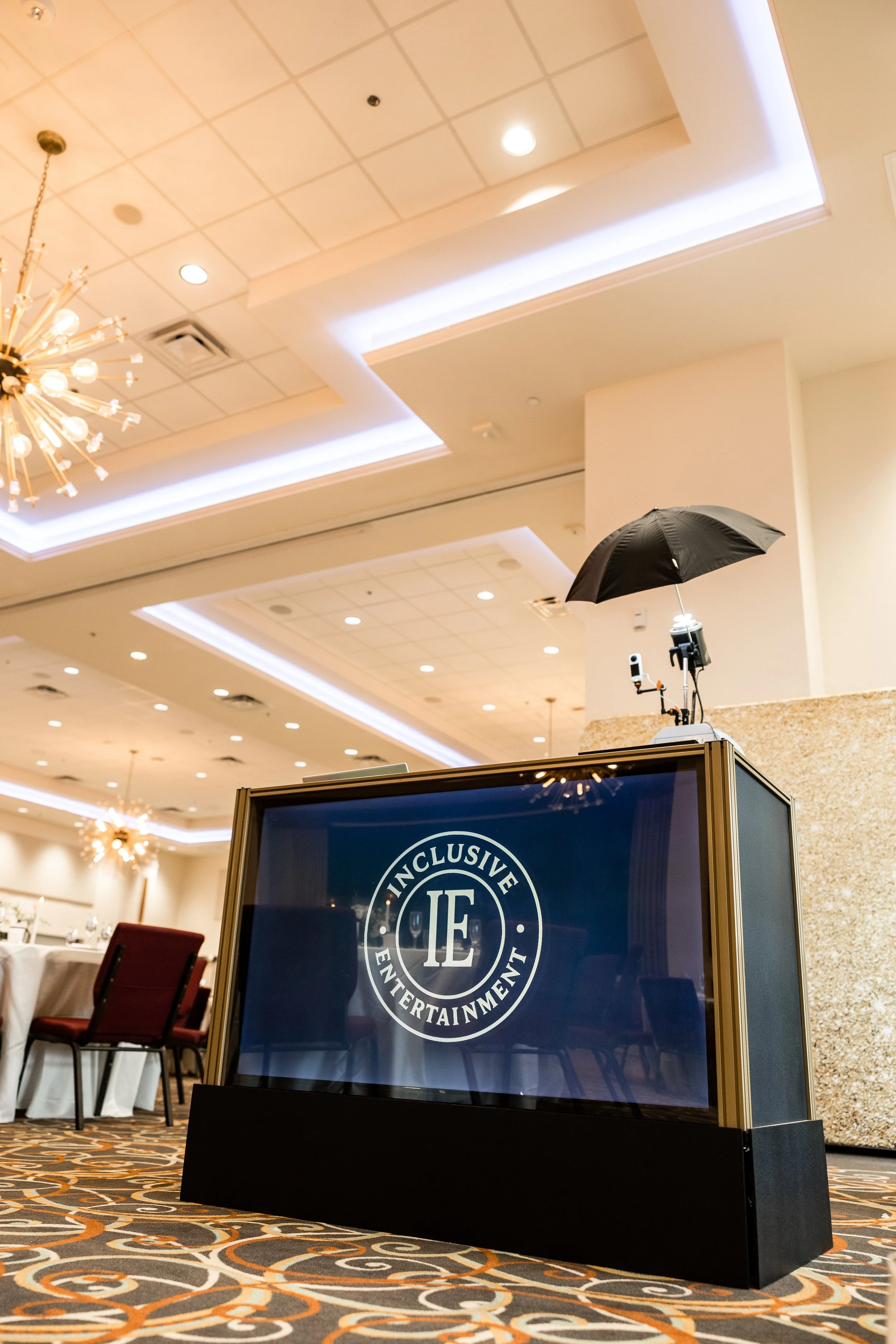 Portrait station photography setup with illuminated digital facade and lighting effects at a wedding reception and banquet venue, Inclusive Entertainment Patty's Pix setup.
