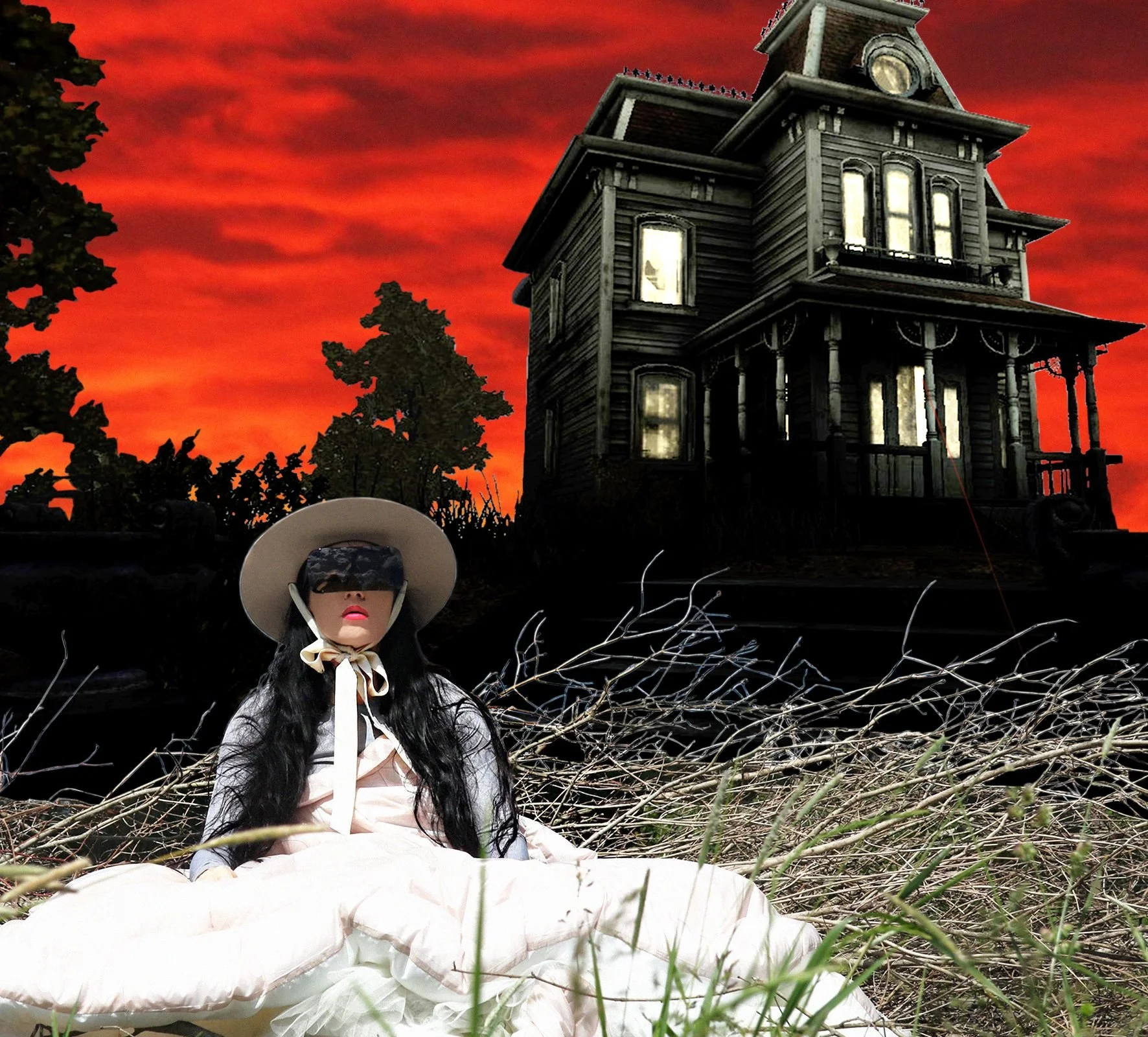 woman sitting in the grass in front of house