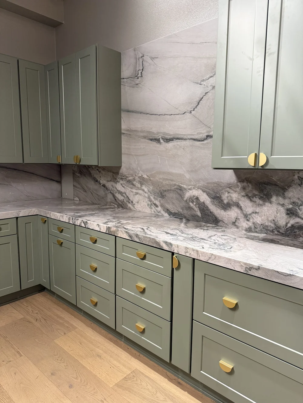 Kitchen remodel with sage green custom cabinets and stone countertops