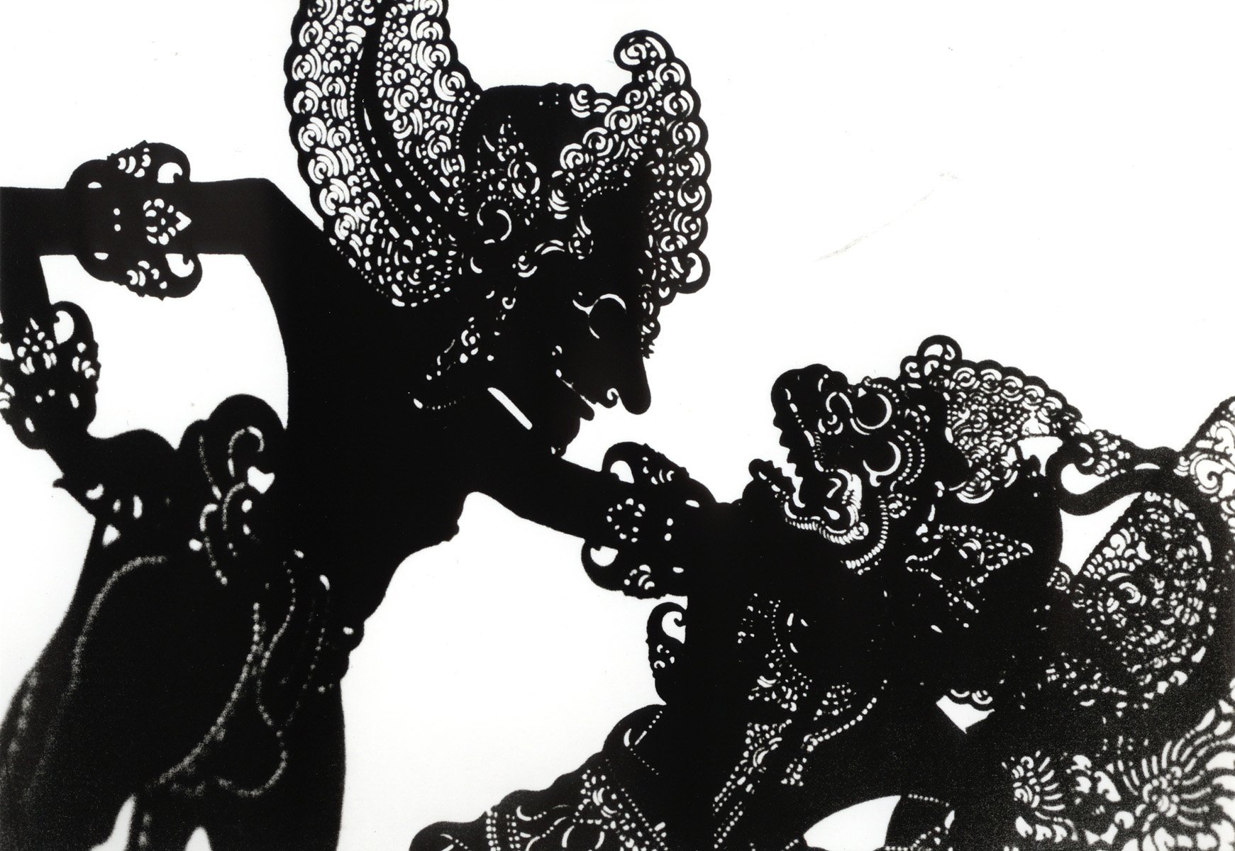 Silhouette of a traditional Indonesian wayang kulit puppet with intricate detailing.
