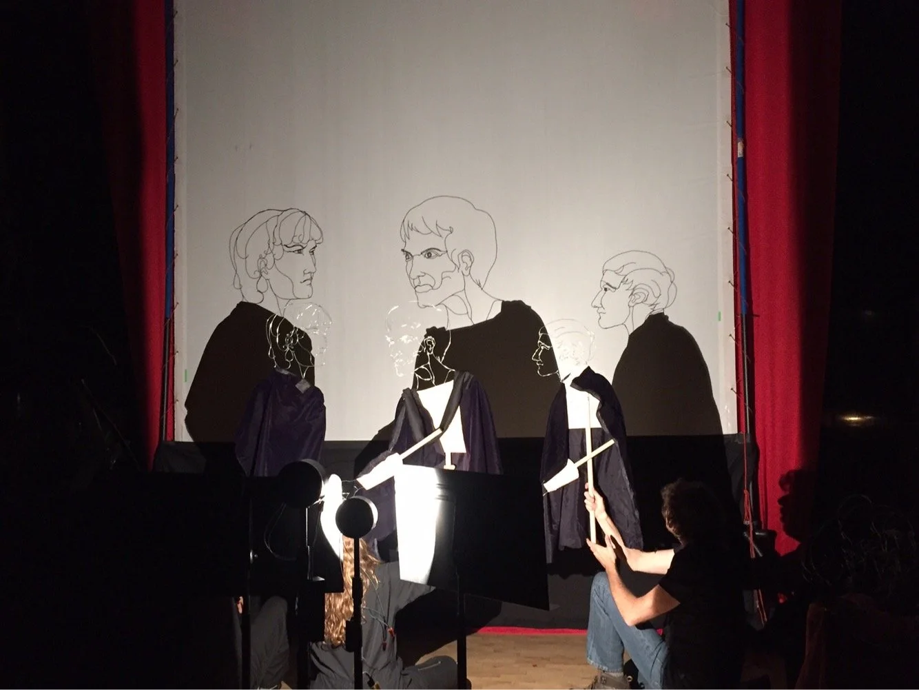 Backstage shot of I Made Moja, Caryl Kientz, and Fred C. Riley III puppeteering the wire puppets.