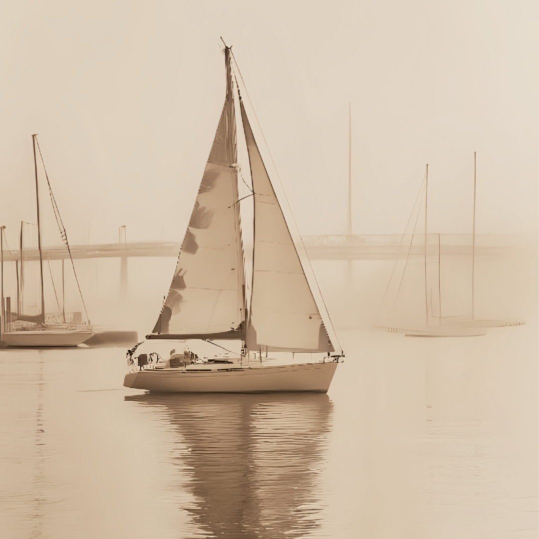Sailboats on calm water with a foggy background, sepia tone.