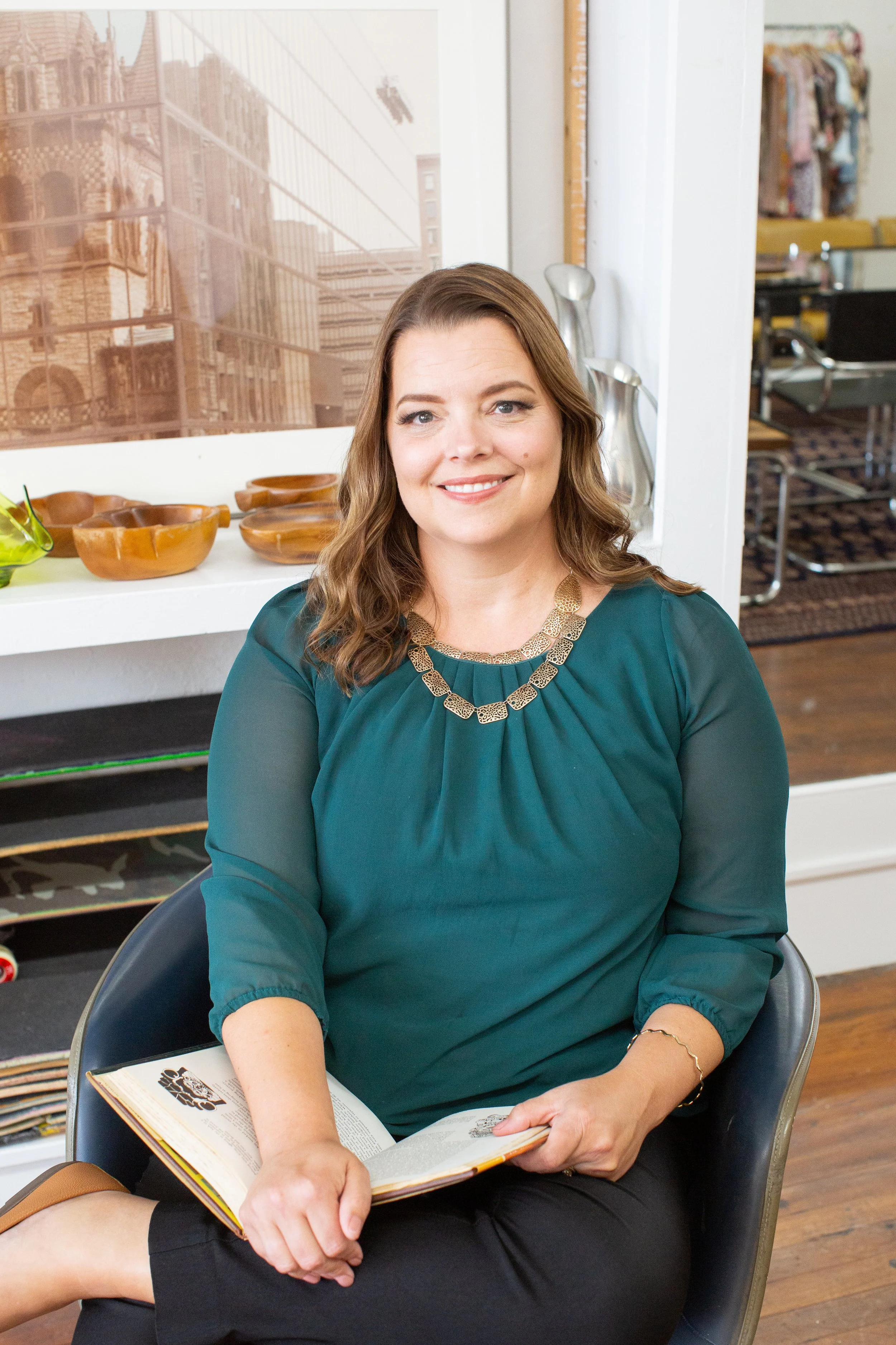Danita Cummins, author and speaker, seated with an open book