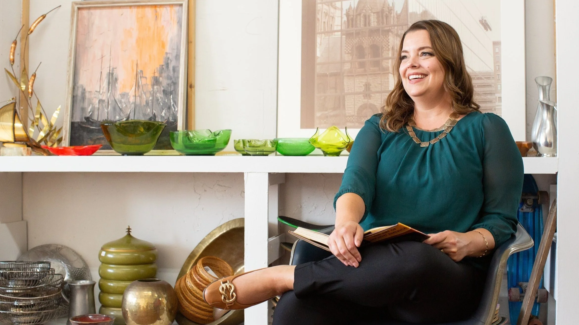 Danita Cummins seated in a chair laughing at the camera.