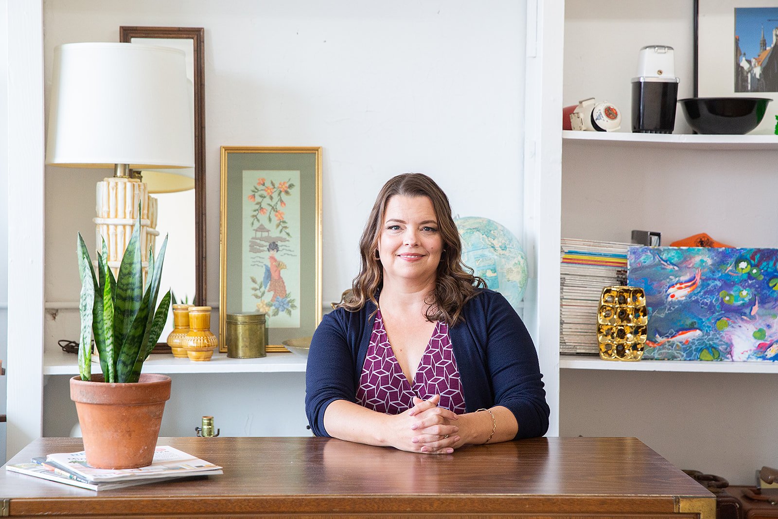 Danita Cummins seated at a wooden table in her writing space