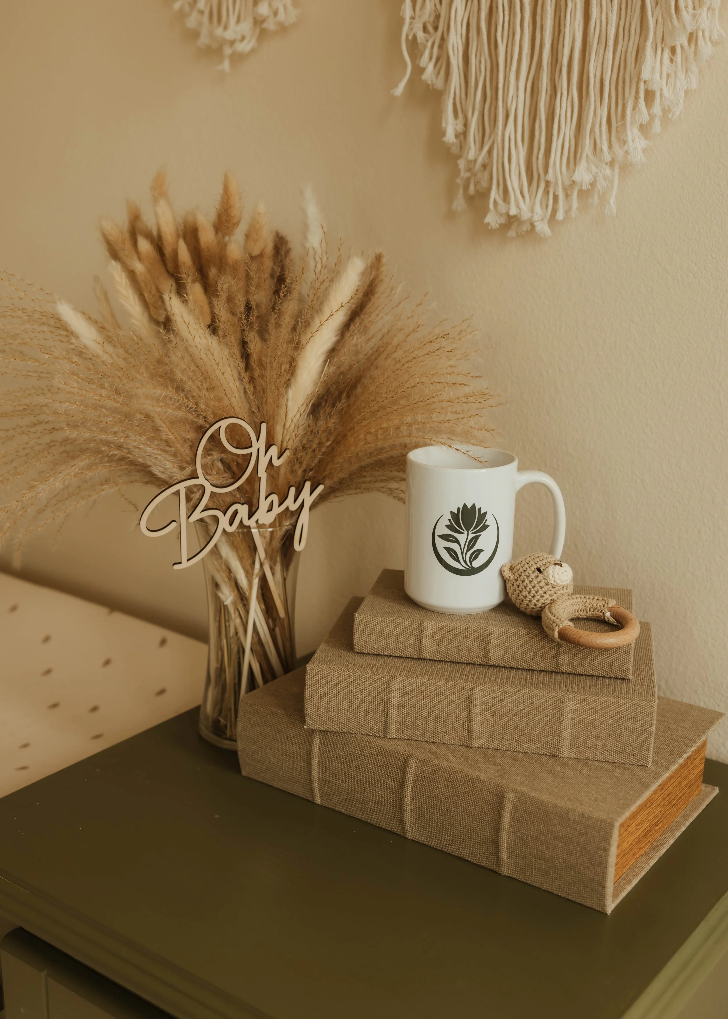 Thoughtfully styled motherhood and postpartum-inspired décor reflecting warmth, nurturing care, family wellness, and the grounded, holistic approach of Root & Rhythm Holistic Care.