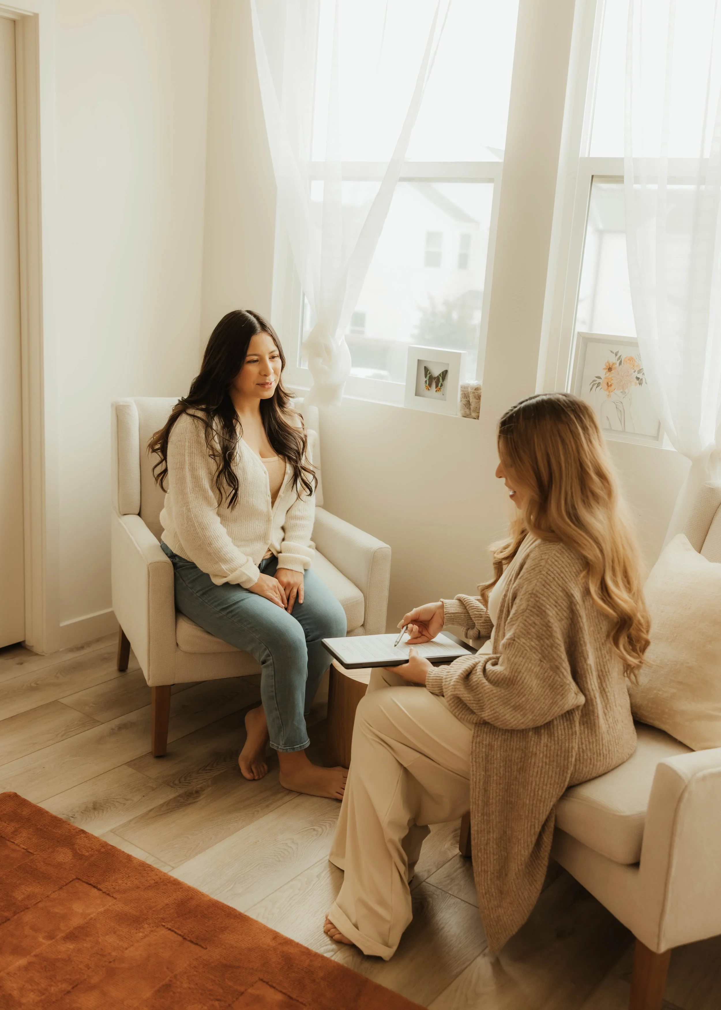 Dr. Salena Gallegos, OTD, OTR/L, meeting with a mother in a calm, welcoming space that reflects supportive conversation, holistic wellness, maternal care, and personalized occupational therapy rooted in real-life routines and everyday function.