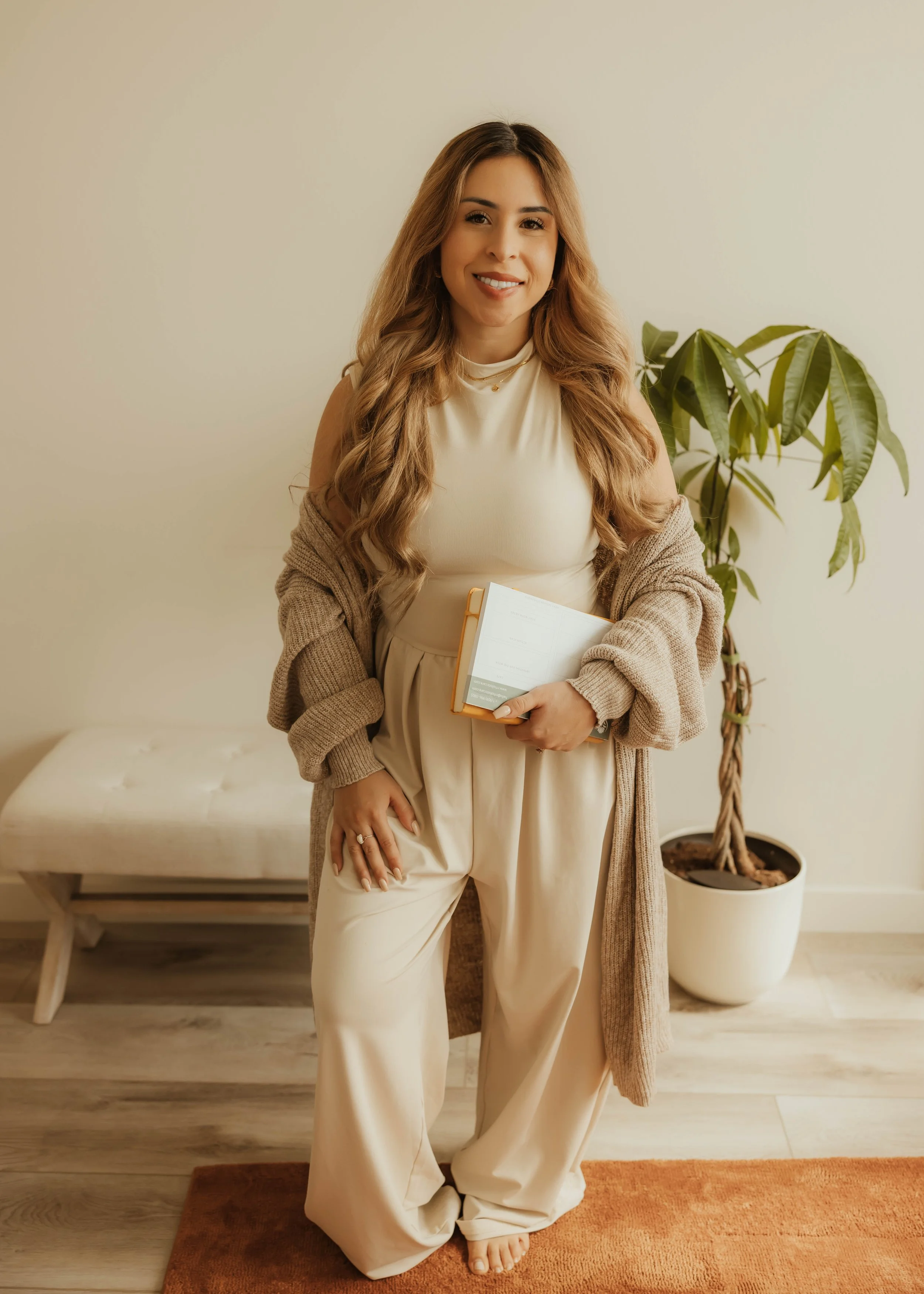 Dr. Salena Gallegos, OTD, OTR/L, founder of Root & Rhythm Holistic Care, in a warm, grounded space that reflects holistic wellness, intentional living, and compassionate support for women, mothers, and families.