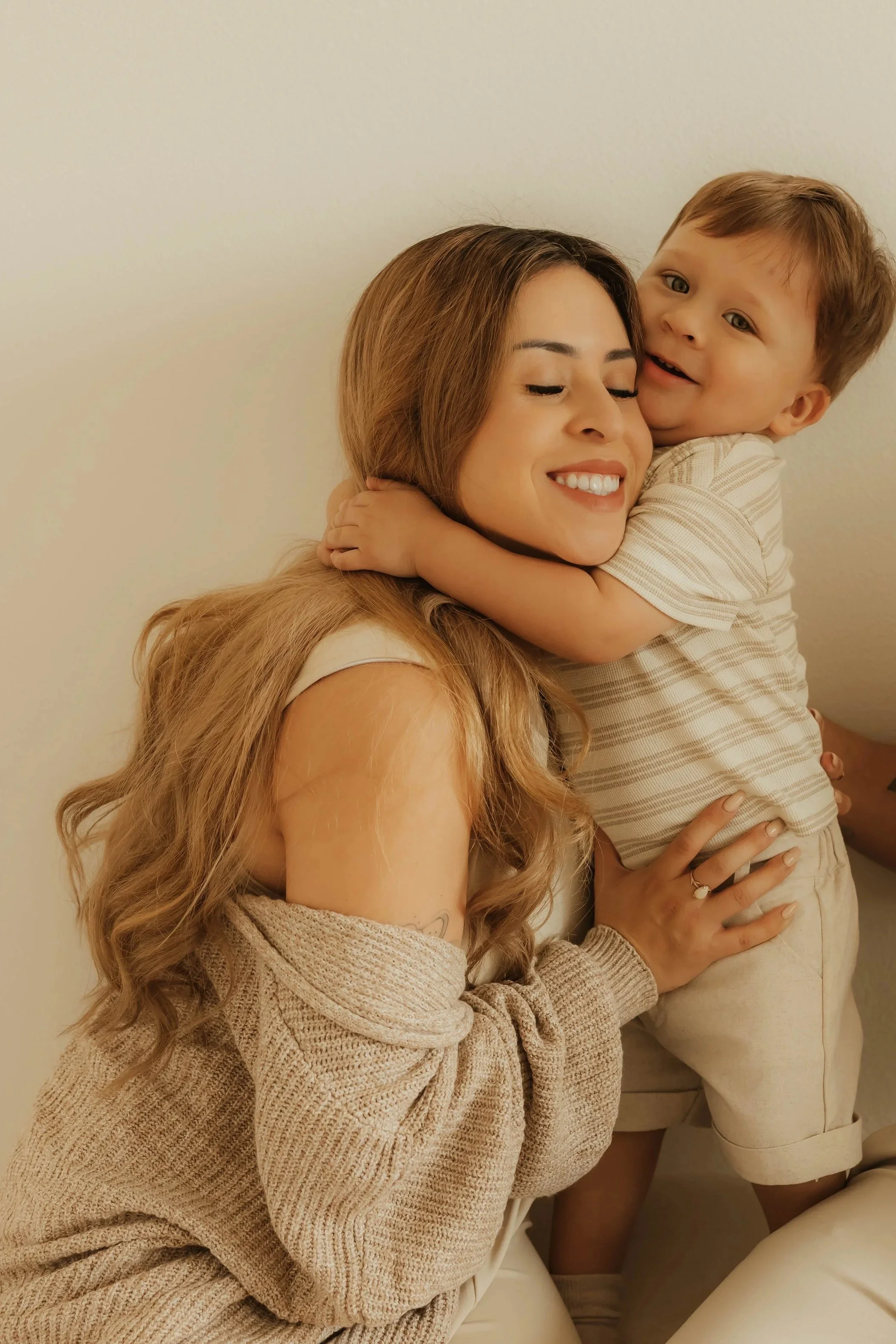 Dr. Salena Gallegos, OTD, OTR/L, sharing a joyful moment with her son that reflects motherhood, connection, family wellness, and the heart of Root & Rhythm Holistic Care.