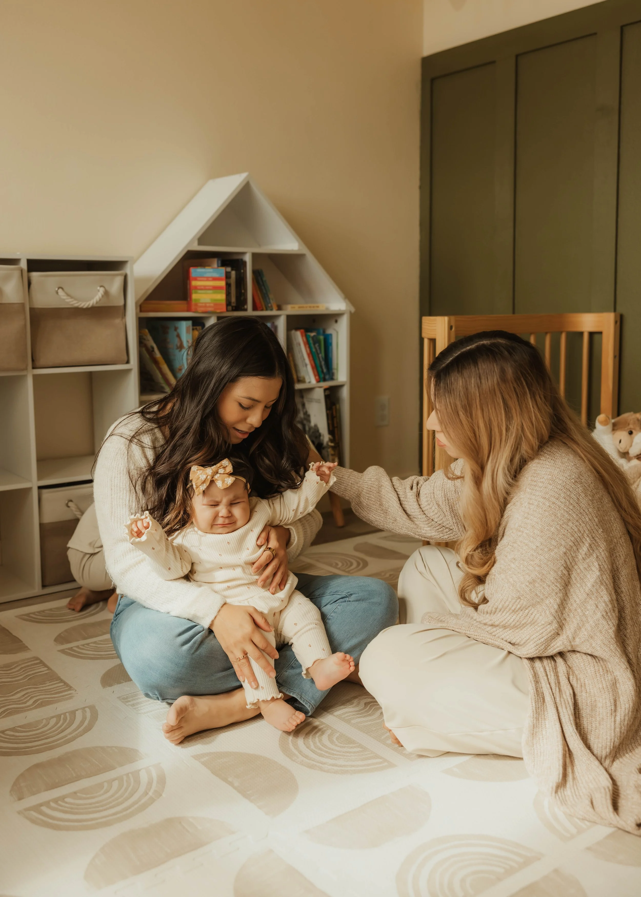 Dr. Salena Gallegos, OTD, OTR/L, supporting a mother and baby in a warm, nurturing environment that reflects postpartum care, emotional support, co-regulation, family wellness, and compassionate occupational therapy rooted in everyday life.