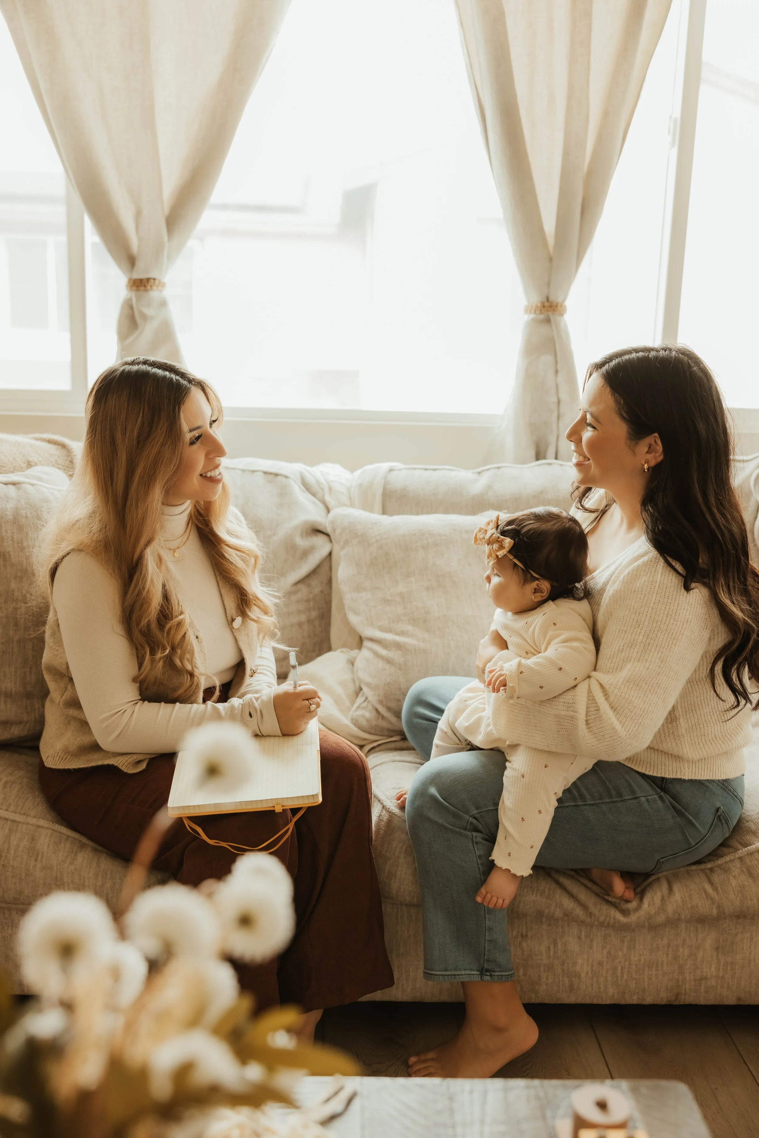 Dr. Salena Gallegos, OTD, OTR/L, supporting a mother and baby in a warm, collaborative environment that reflects personalized care, family wellness, emotional support, and holistic occupational therapy through Root & Rhythm Holistic Care.