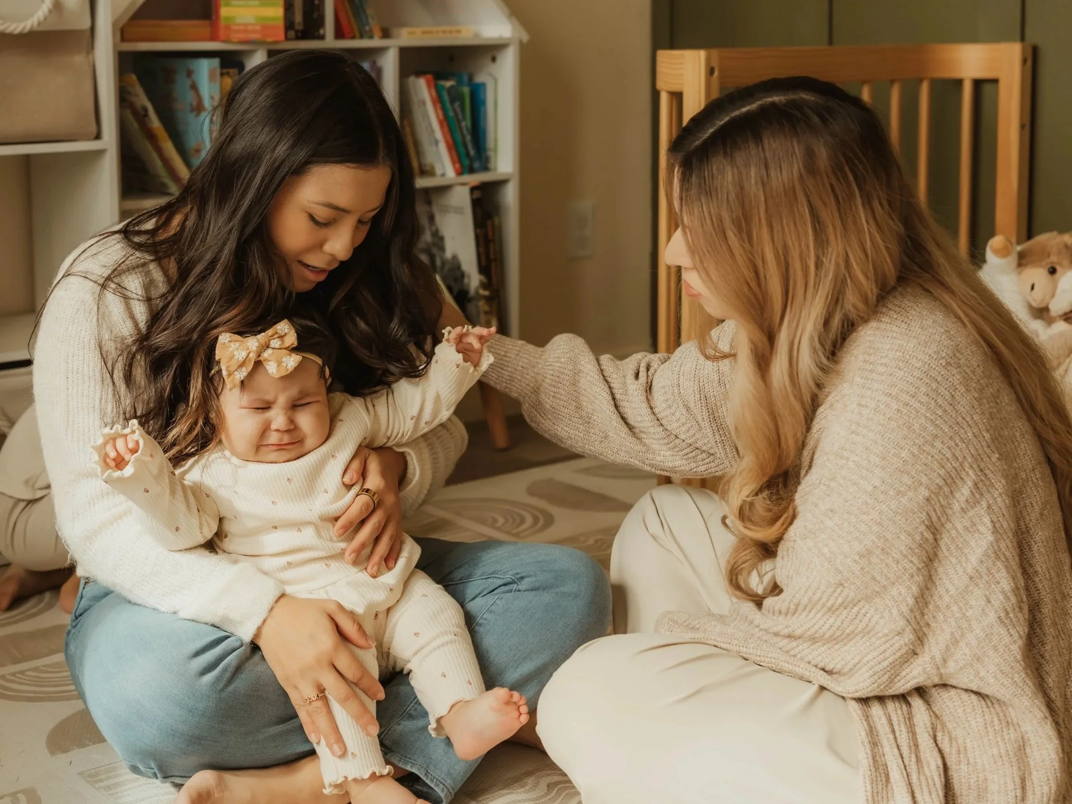 Dr. Salena Gallegos, OTD, OTR/L, supporting a mother and child through a moment of emotional regulation and connection, reflecting compassionate, family-centered occupational therapy and holistic care through Root & Rhythm Holistic Care.