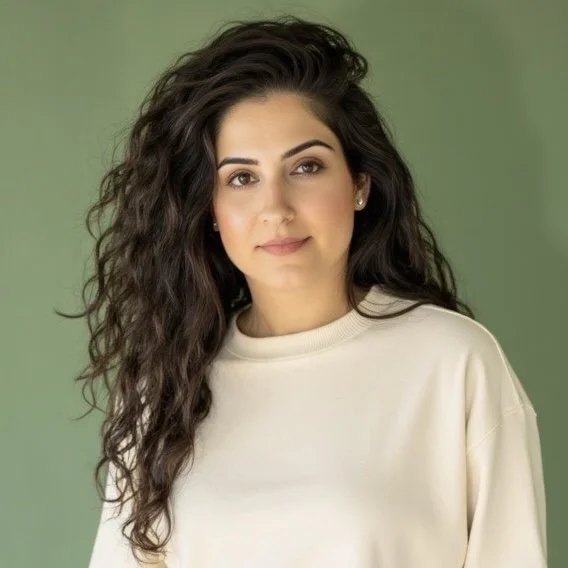 Mana Rasoulzadeh in a cream sweatshirt, standing against a green background—BASEique branding image