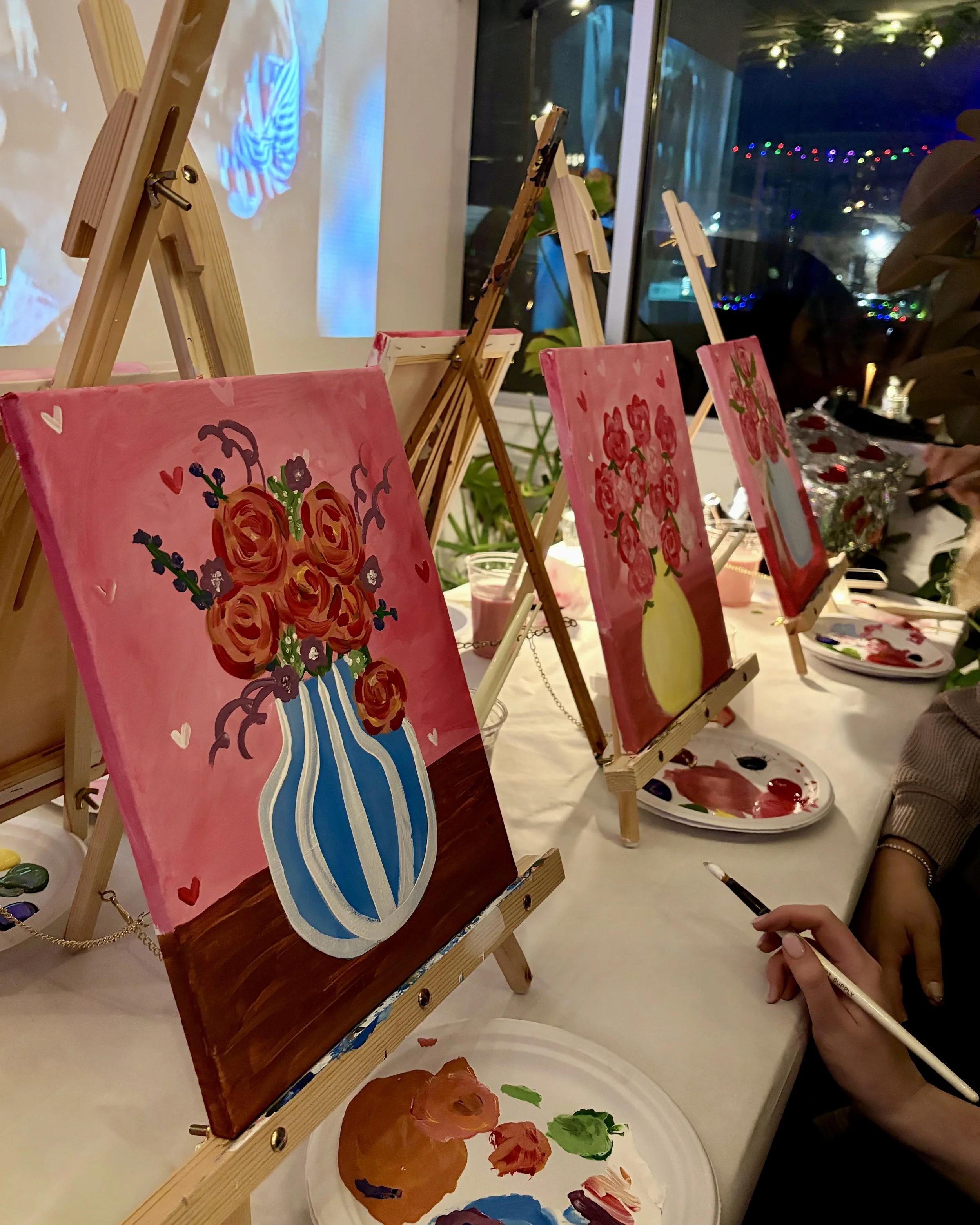 Up close photo of three bouquet paintings at an angle