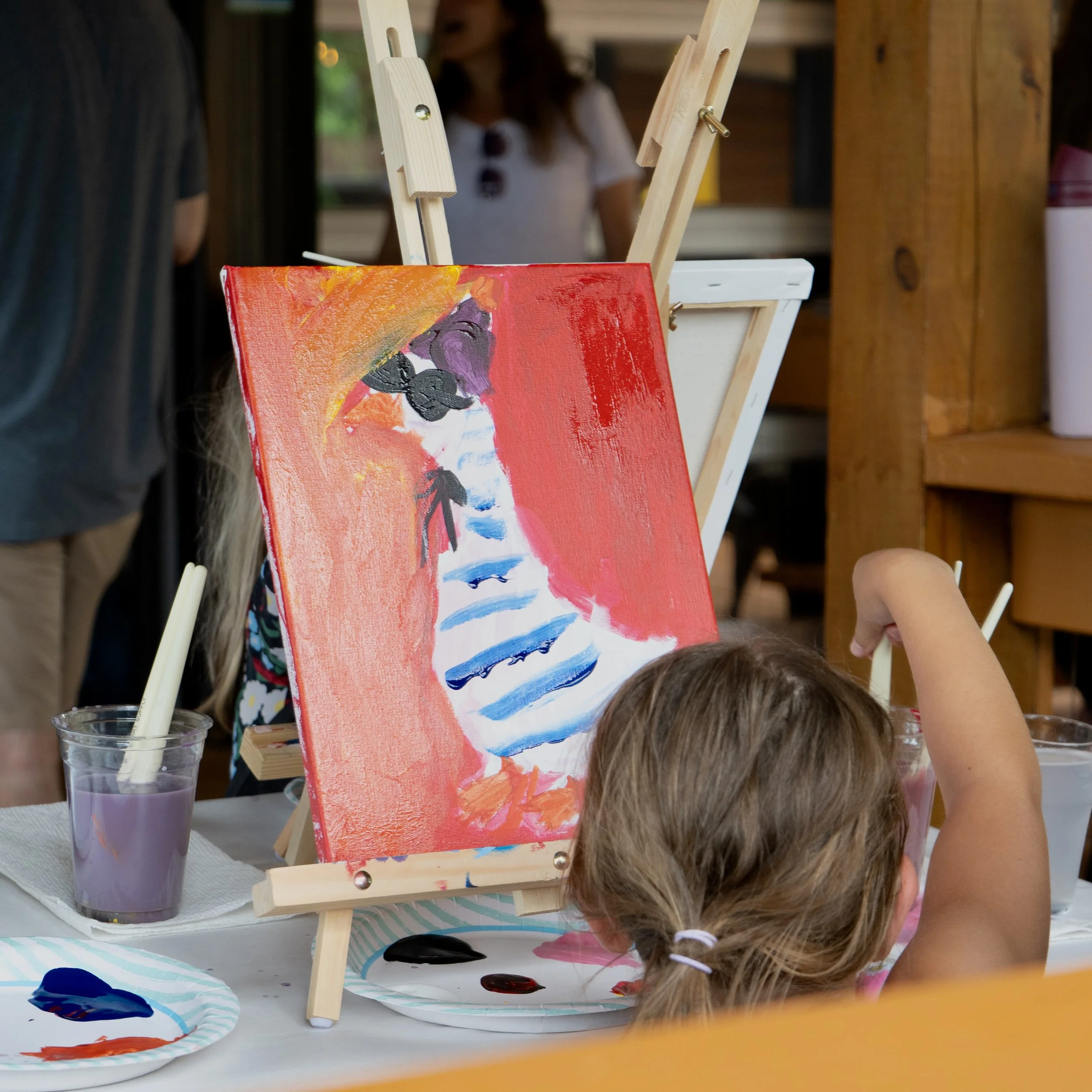 Close up of a red and blue striped goose painting