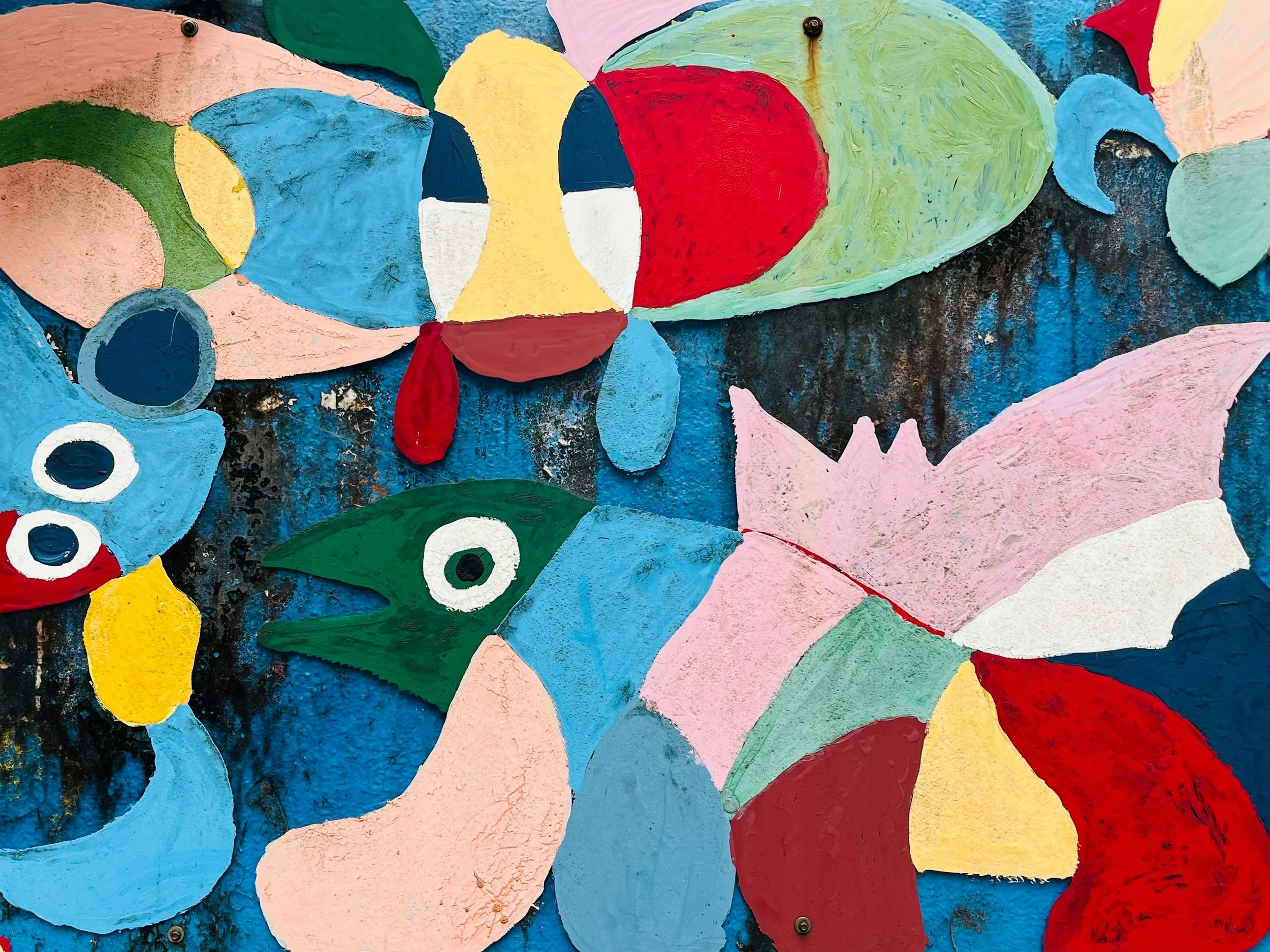 Colorful paper cutout creatures in primary colors