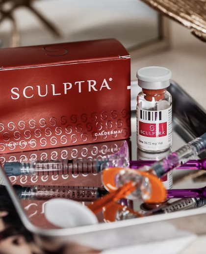 Medical syringes and a vial of Sculptra on a tray