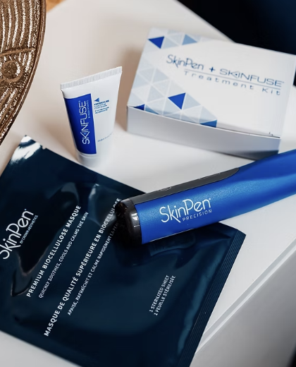 SkinPen skincare treatment kit with a tube, a boxed set, a pen device, and a packet on a white surface.