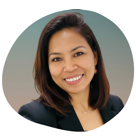 A smiling woman with shoulder-length brown hair and a green background.
