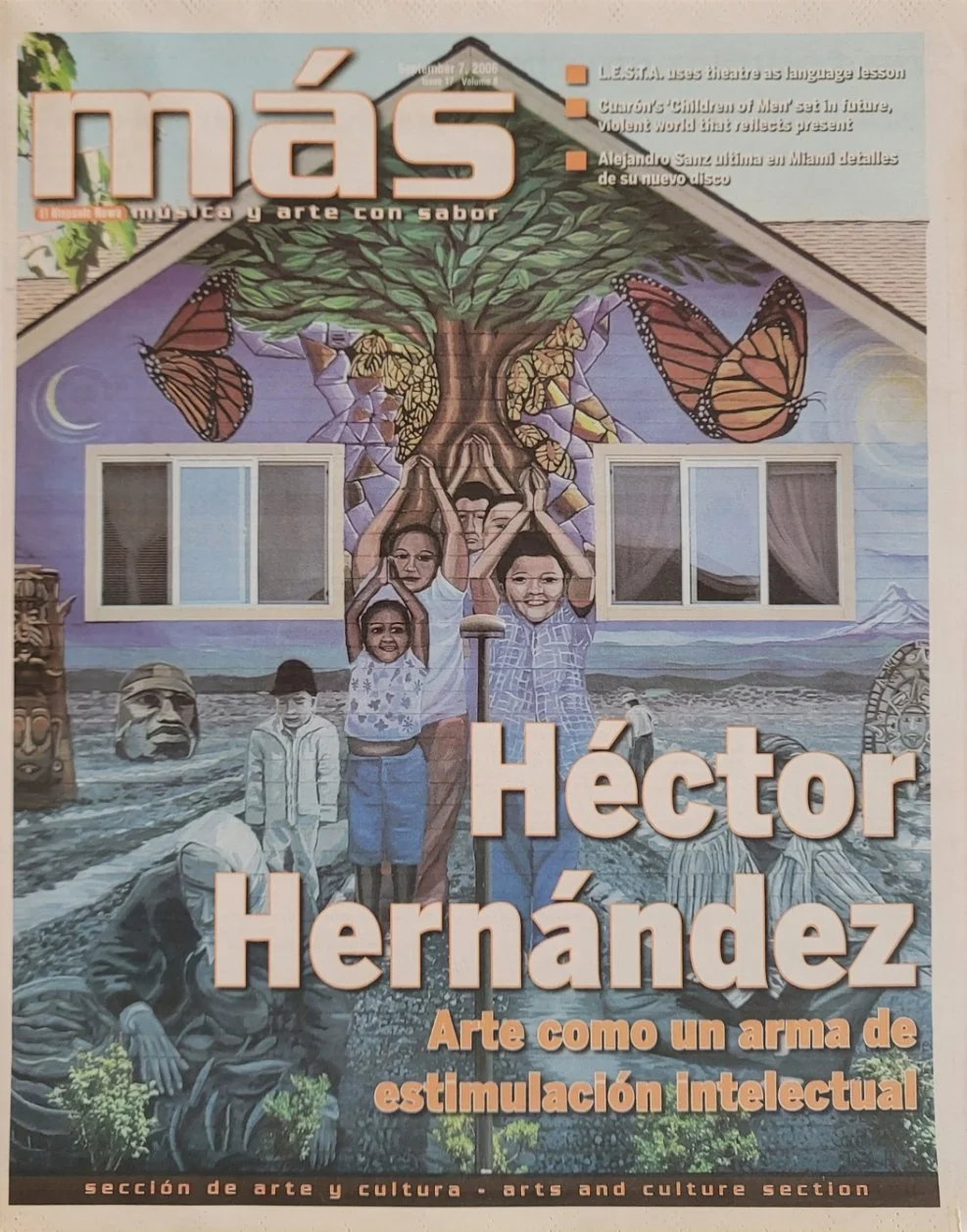 Colorful mural showing a tree with butterflies, a landscape with mountains, a moon, and a group of people, including children and adults, in traditional and modern clothing, surrounding the tree. The mural features faces, a large eye, and artistic elements representing culture and nature. This is a cover of a magazine or publication titled 'más' with headlines about art and culture.