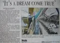 A newspaper clipping with the headline 'It’s A Dream Come True,' featuring a photo of a person standing on a boat or dock near water.