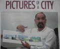 Man holding architectural drawing or blueprint in front of a poster titled 'PICTURES OF CITY'