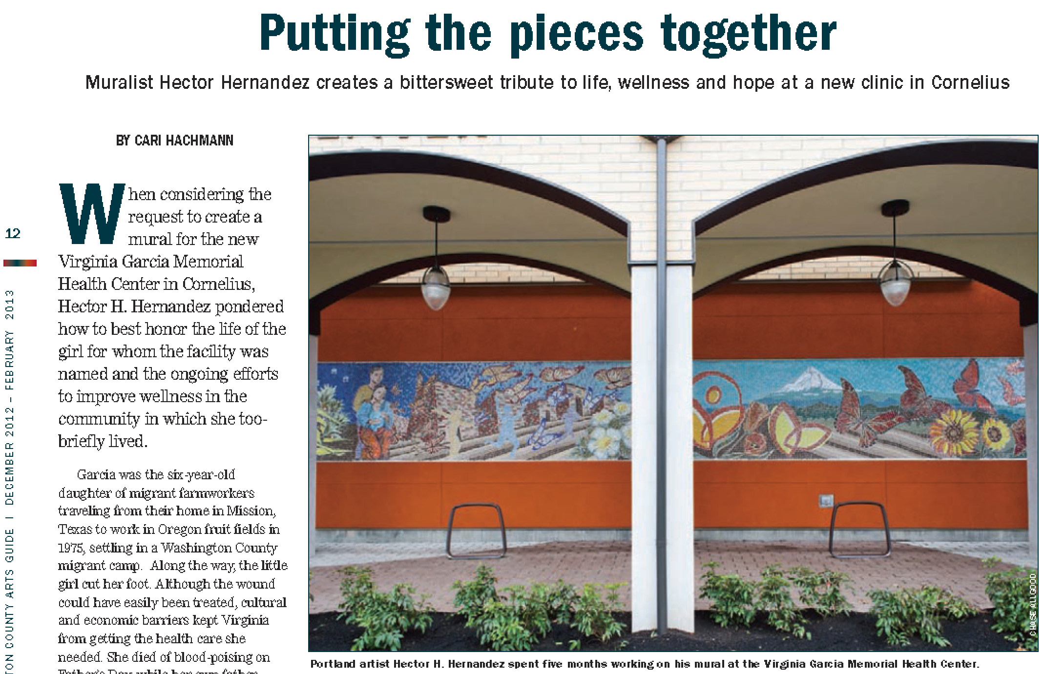 A mural created by Hector Hernandez at the Virginia Garcia Memorial Health Center features a nature scene with butterflies, sunflowers, a mountain, and a rainbow, displayed on an exterior wall beneath two archways with hanging lights.