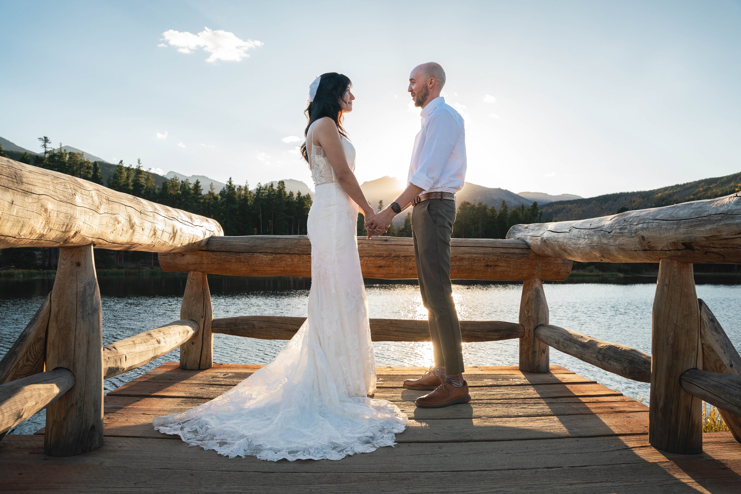 A couple holding hands, sharing their vows during a wedding elopement at Rocky Mountain National Park, Colorado