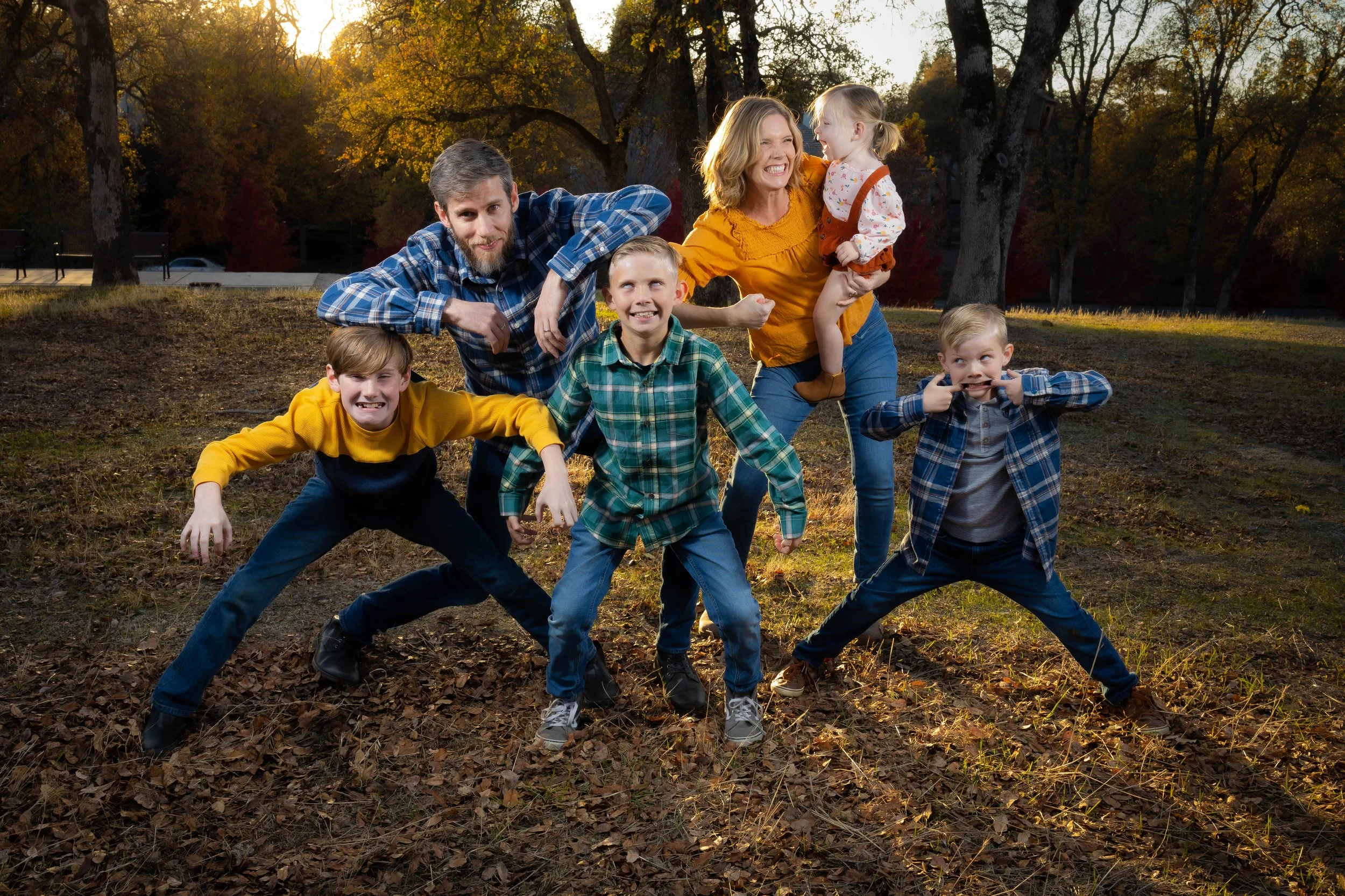Fun family photography session in autumn park with a family of six, making silly faces and poses, captured by An Entropy Production.. Family photography with An Entropy Production