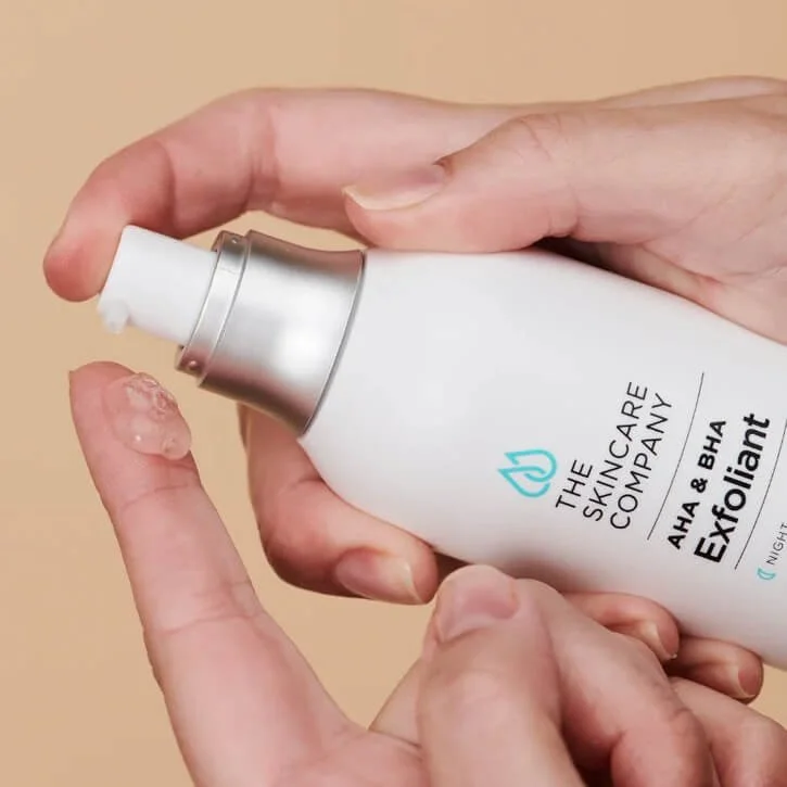 The Skincare Company Exfoliant Serum being dispensed onto a fingertip.