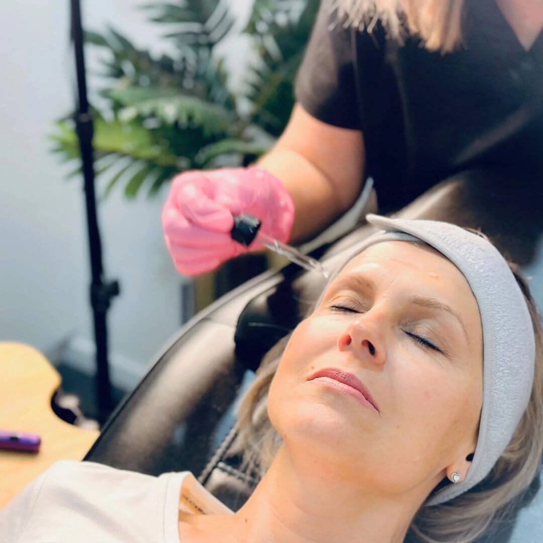 Registered Nurse Jolieta preparing to apply PRX Plus brightening therapy to a client during a skin rejuvenation treatment.