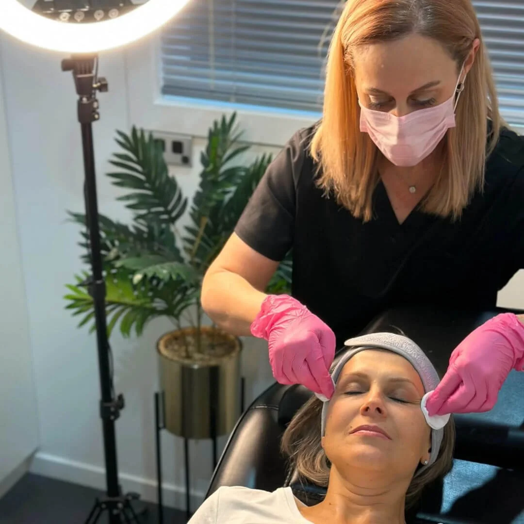 RN Jolieta performing a PRX Plus no-peel biostimulator treatment on a client for brighter, healthier-looking skin.