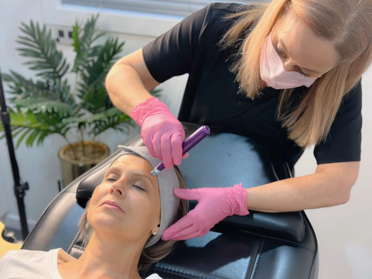 Cosmetic nurse Jolieta performing SkinPen microneedling on a client.