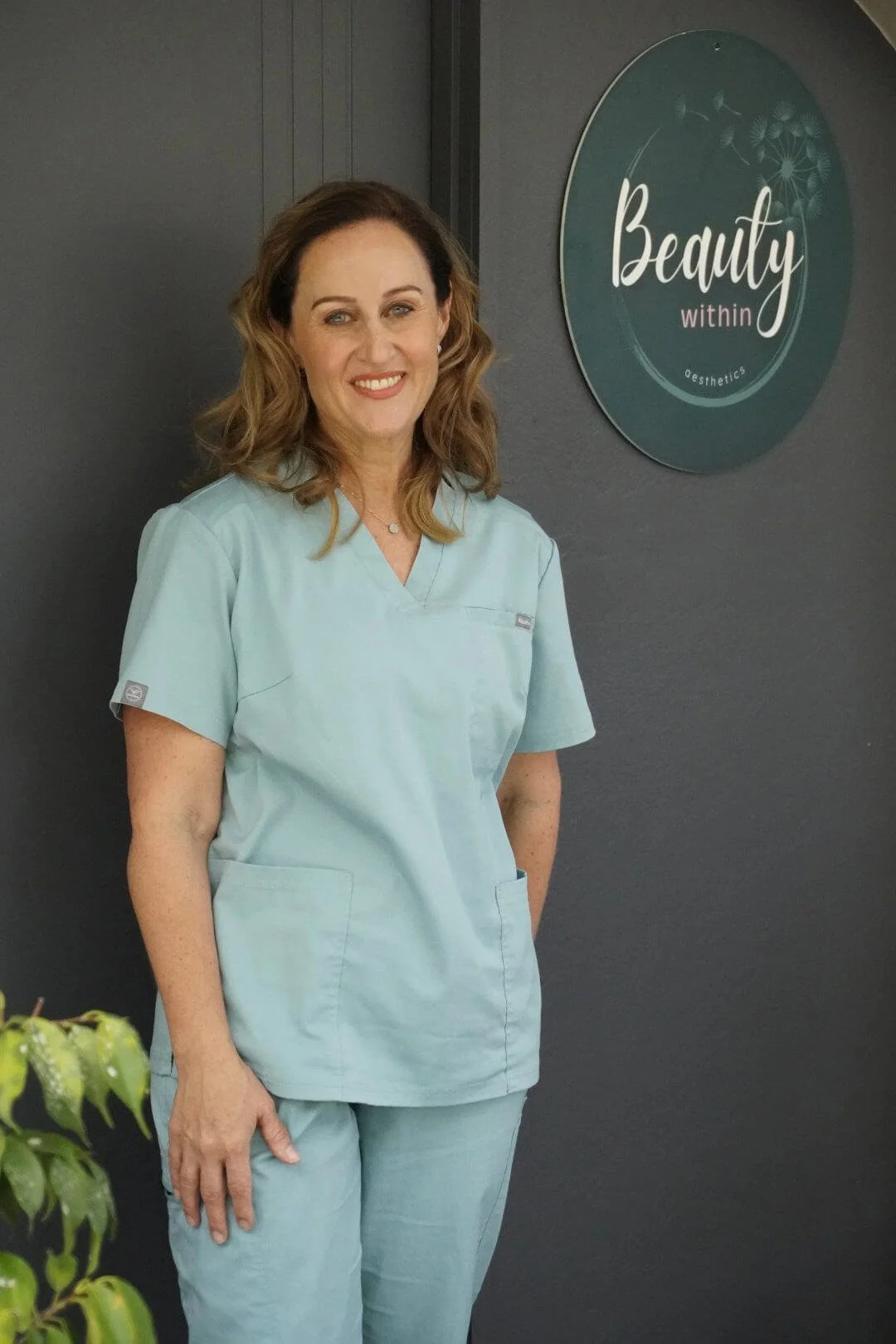 Registered Nurse Jolieta outside Beauty Within Aesthetics clinic.