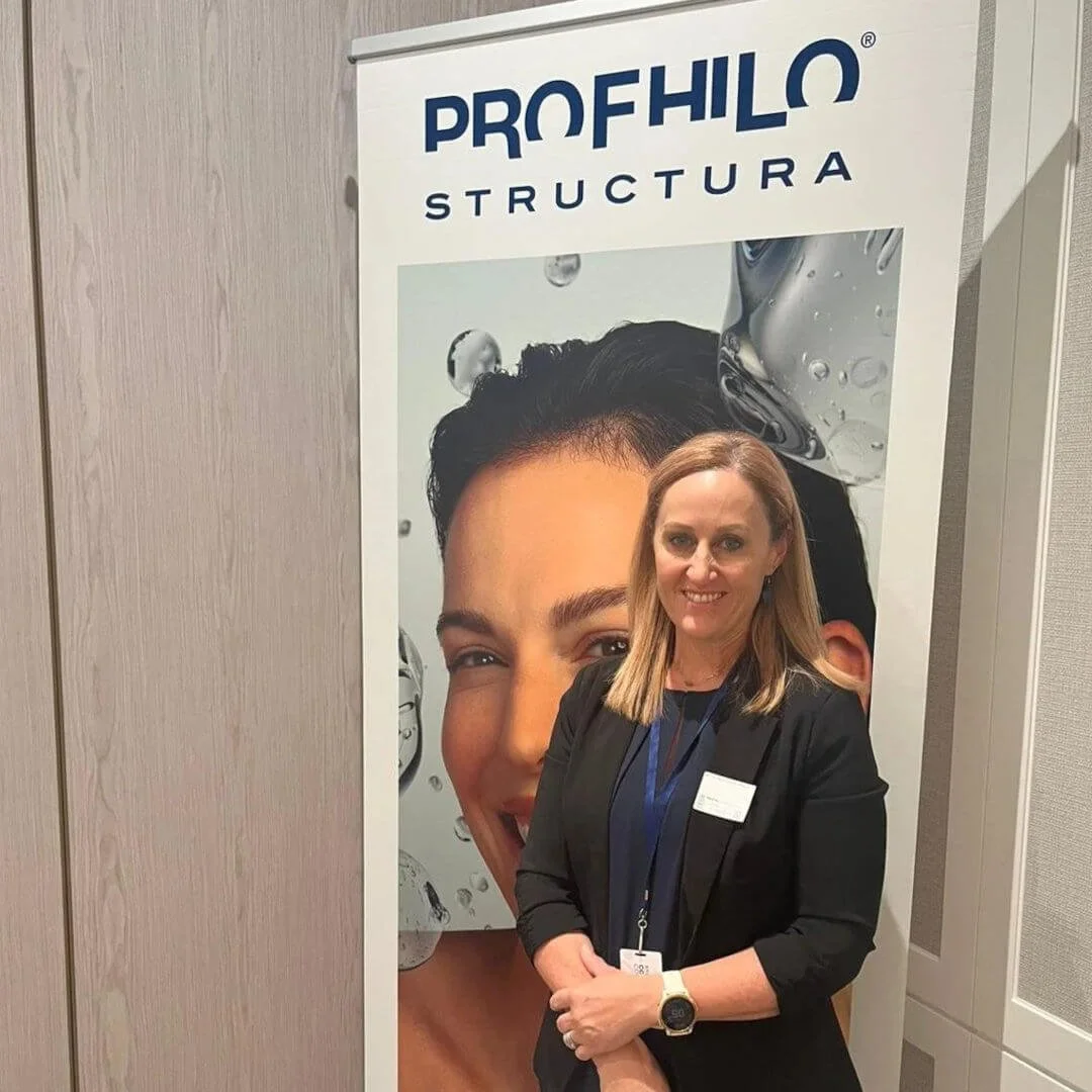 RN Jolieta attending a professional training session focused on facial assessment and aesthetics practice.