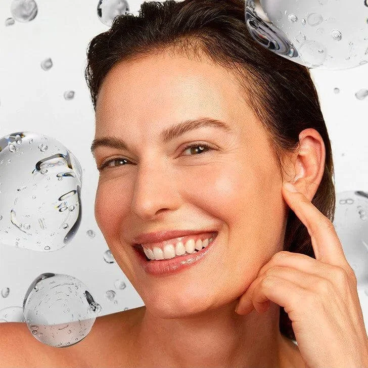 Client touching her cheek on the facial volume and contour consultation page.