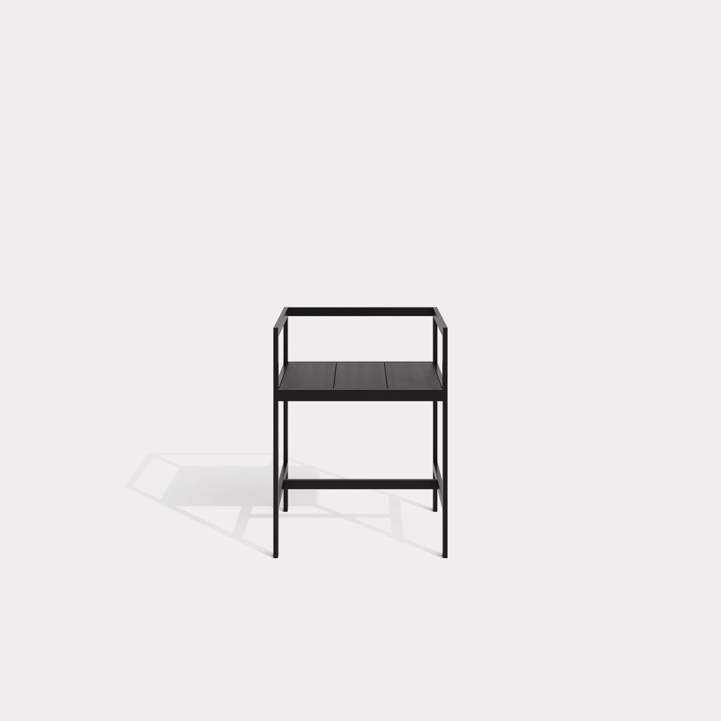 Black metal standing shelf with three tiers and open sides, casting a shadow on a plain white background.