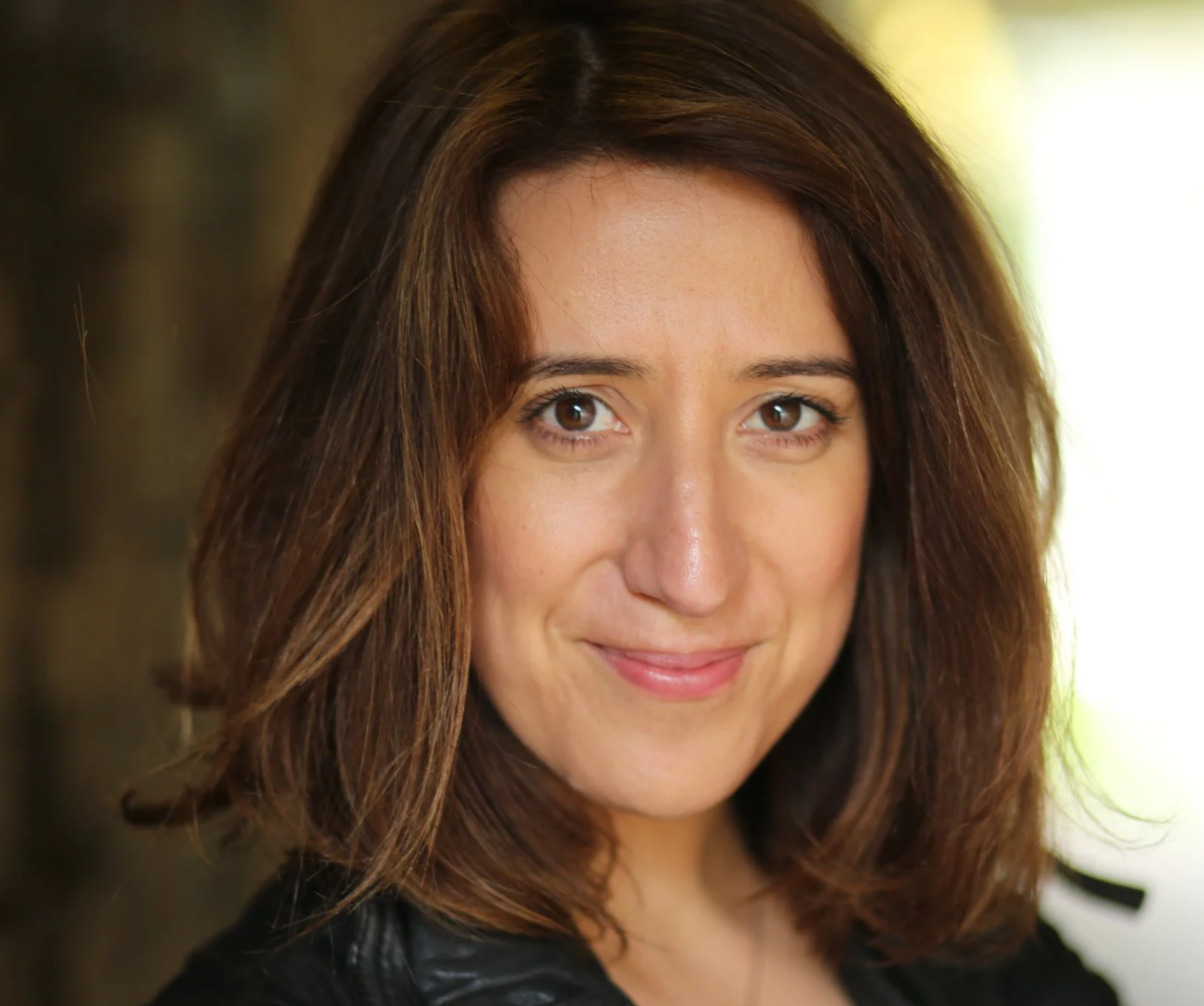 Close-up portrait of Rachel Edwards, a smiling woman with shoulder-length brown hair and brown eyes