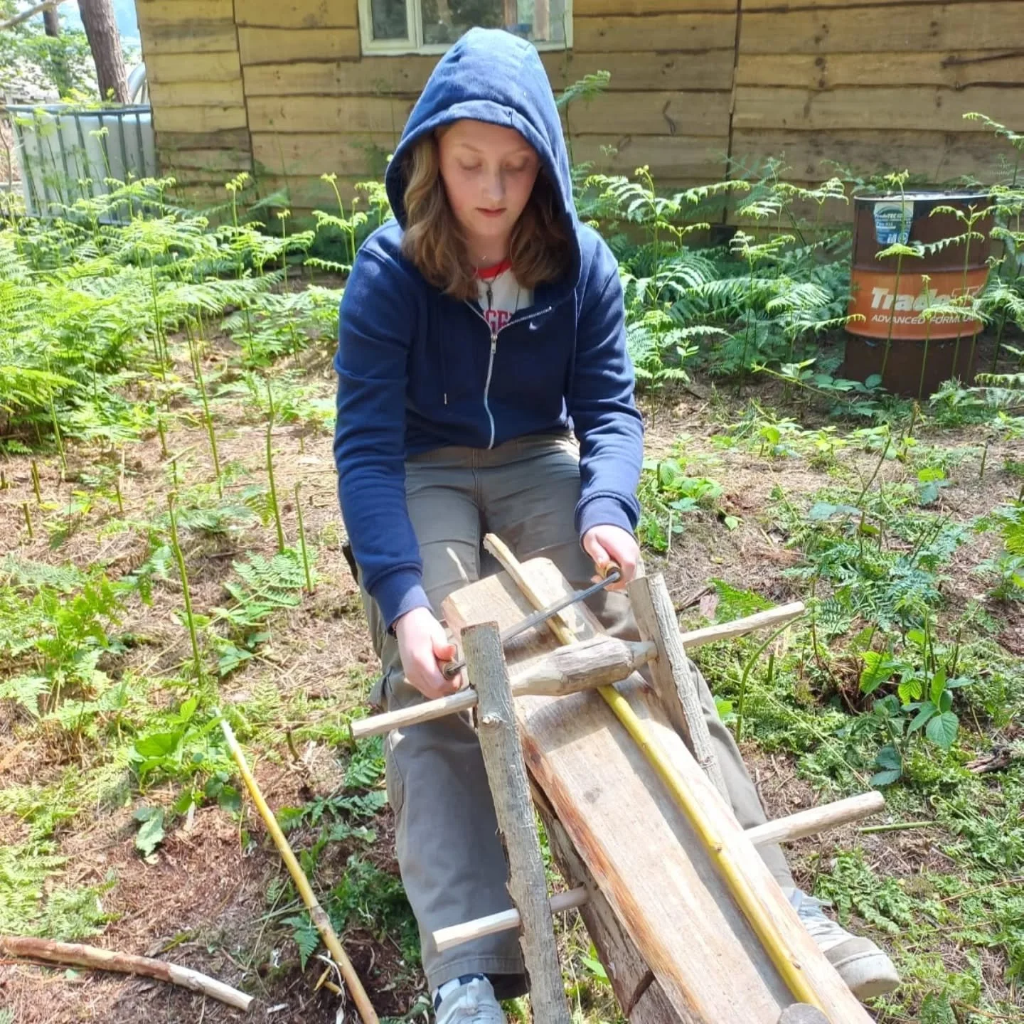 Wooden workshop space and bushcraft experience for community groups and kids clubs. Children engaged in traditional green woodworking using a shave horse, which is a traditional, foot-operated woodworking vise and workbench combination. 
If you are l