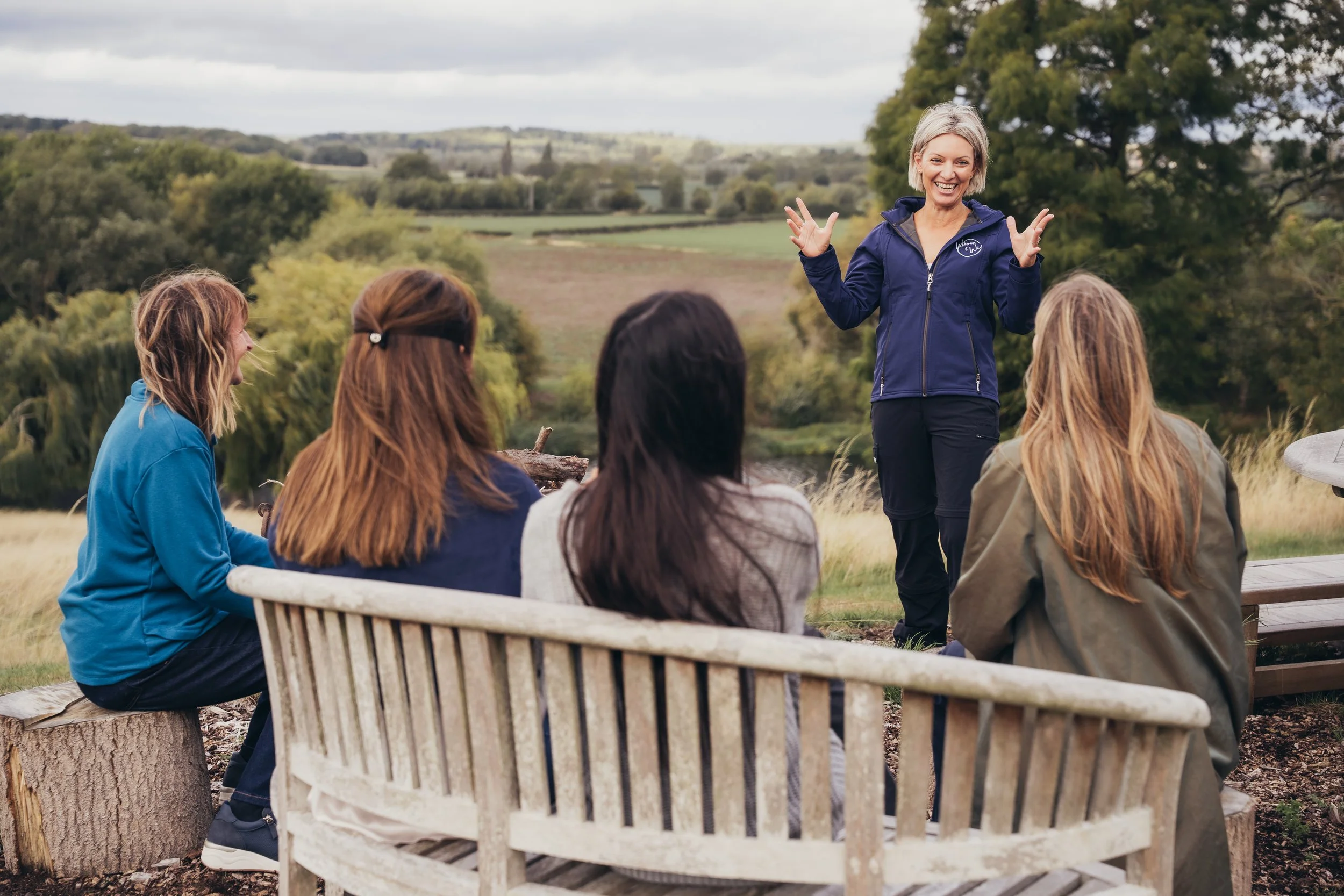 Dr Kate Mason leading a group wellbeing session for women outdoors