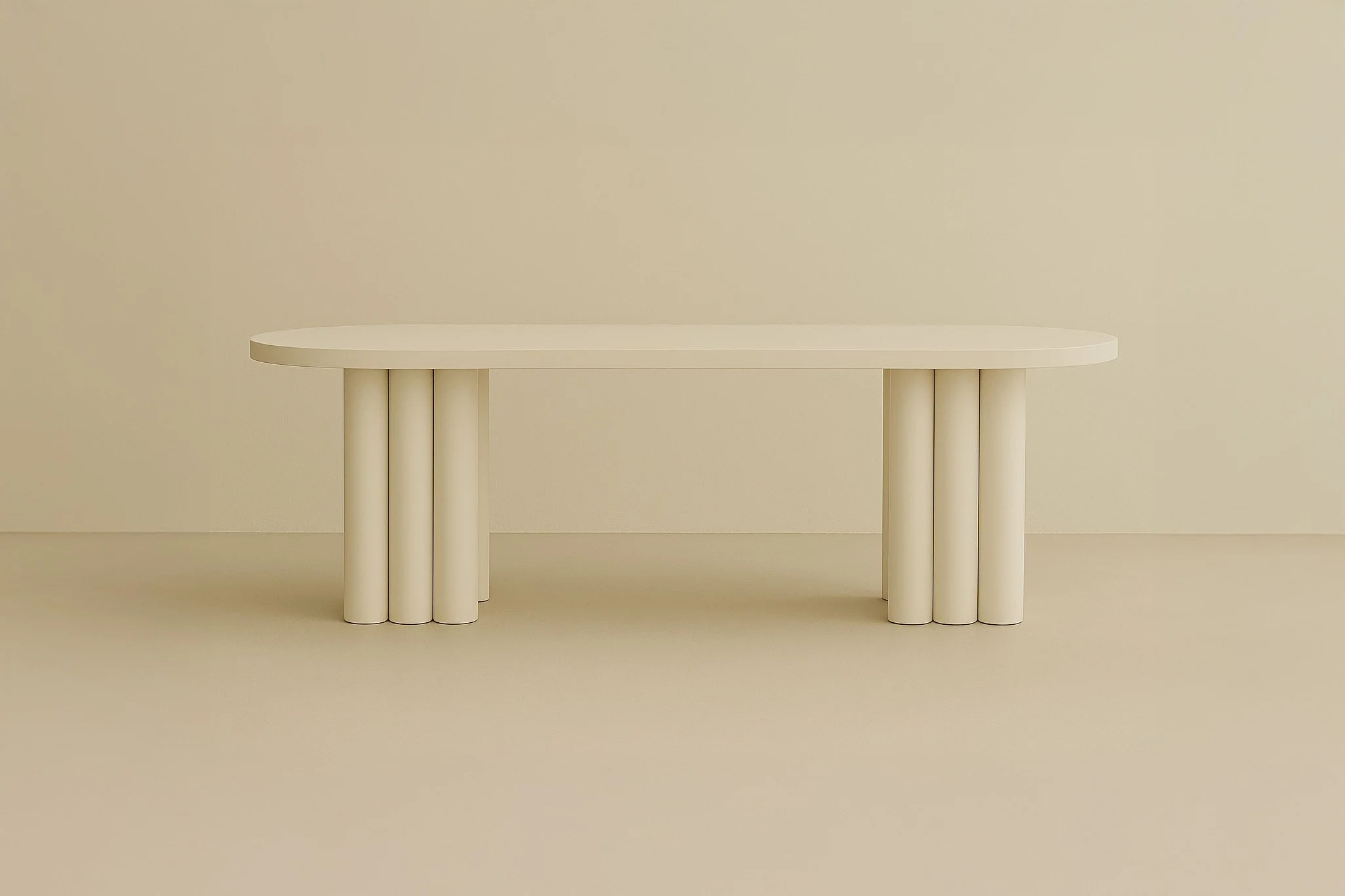 A modern, minimalist white oval table with cylindrical legs in an off-white room.