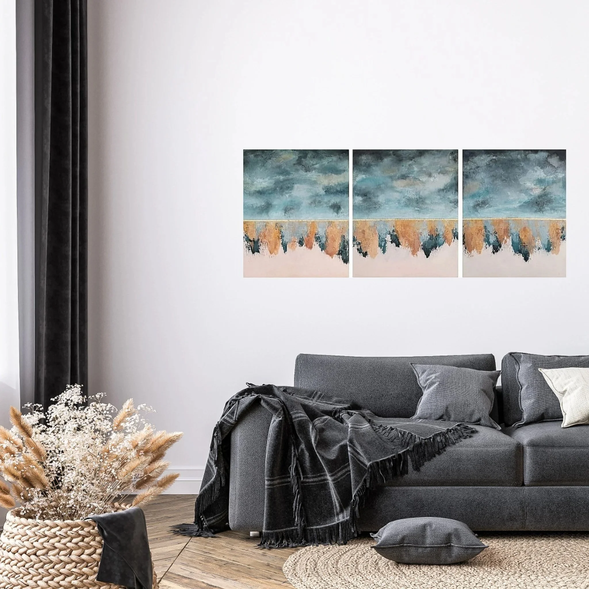 Living room with gray sofa, black throw blanket, dark gray pillows, a circular woven rug, dried flowers in a basket, framed abstract painting on white wall, black curtain on left side