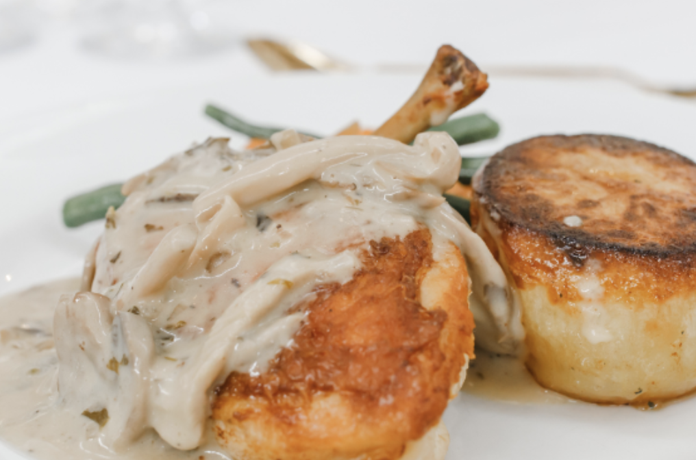 Fried chicken topped with creamy mushroom gravy, served with green beans and mashed potatoes.