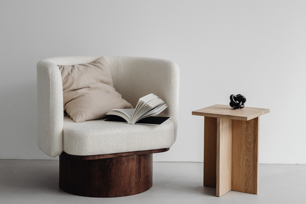 White armchair with an open book and a coffee table