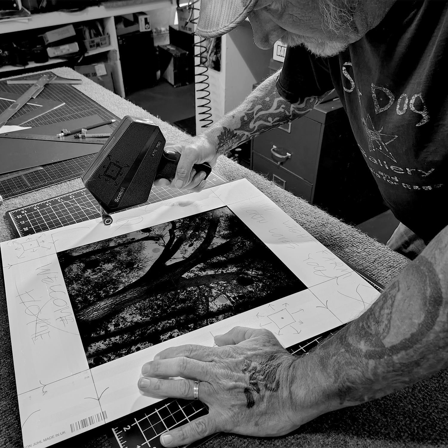 Shannon Graham adding tape to photographic mat board.