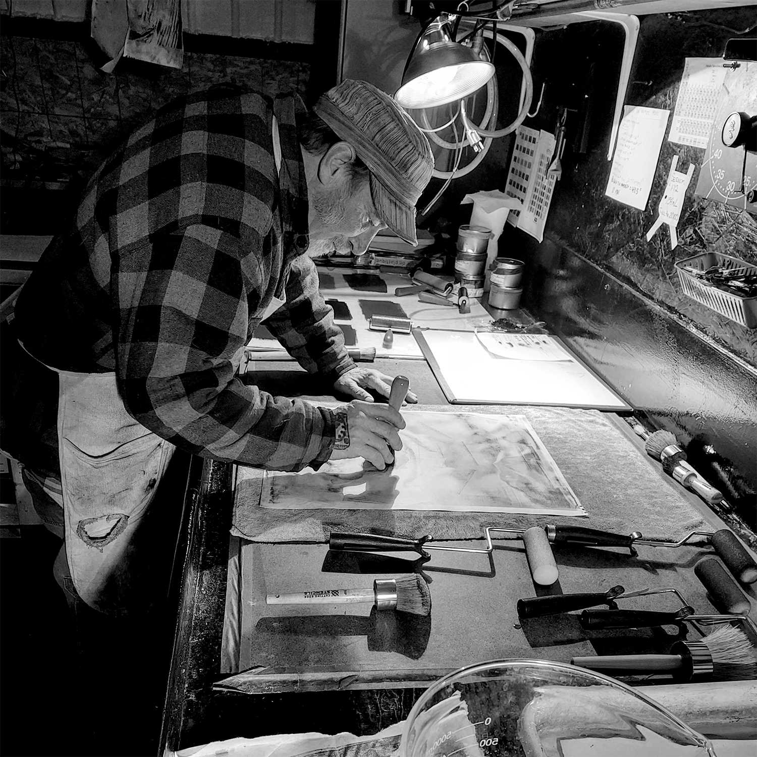 Shannon Graham applying ink with brush to bromoil photograph.