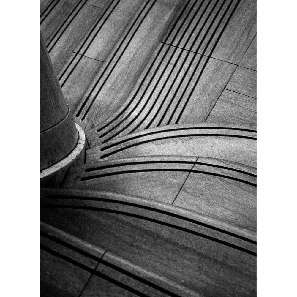 B&W hand-printed photograph showing details of spiraling staircase leading to a NYC subway.