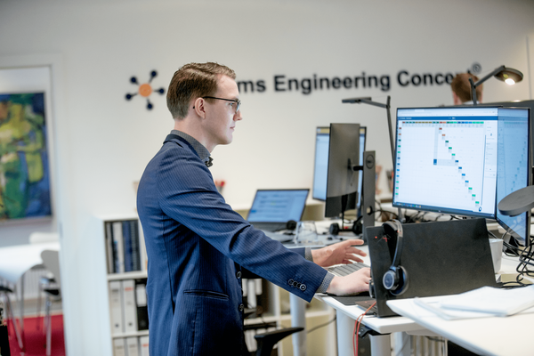 a man working with the RDS 81346 software at a desk