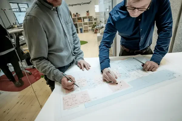 Two engineers going over a design document